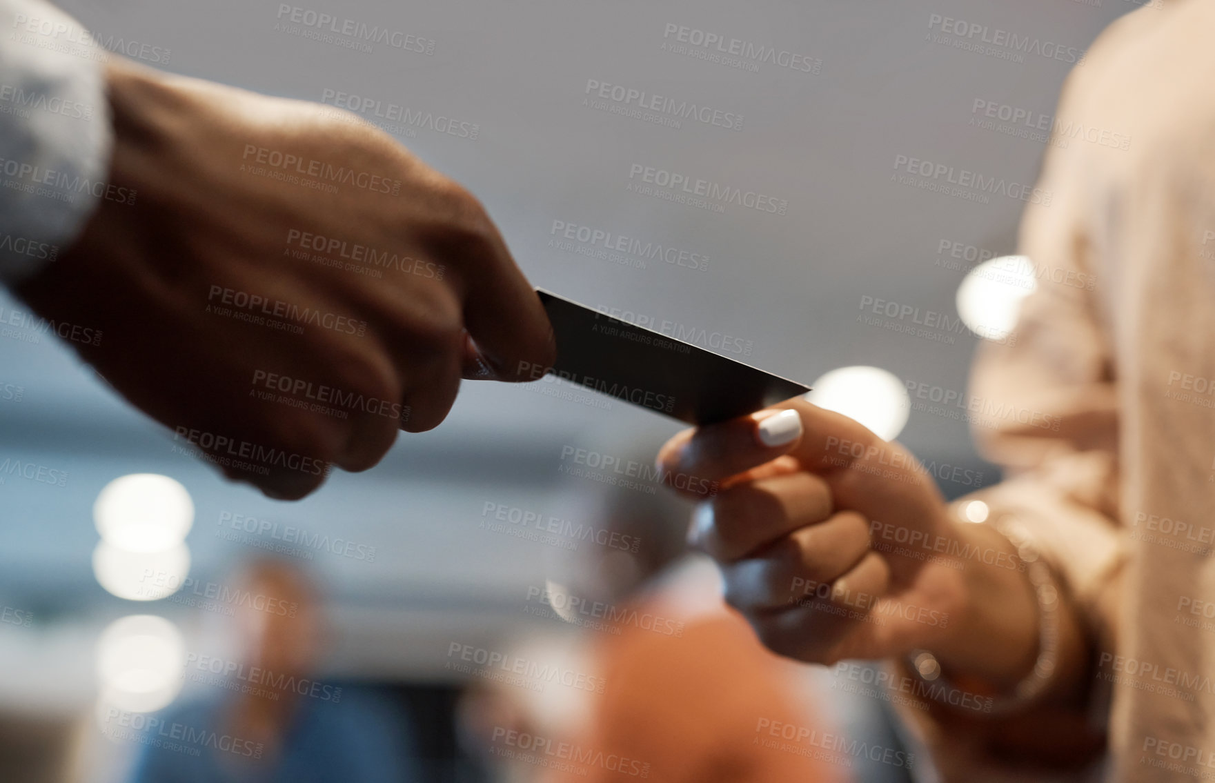 Buy stock photo Shot of two businesspeople exchanging business cards at a conference