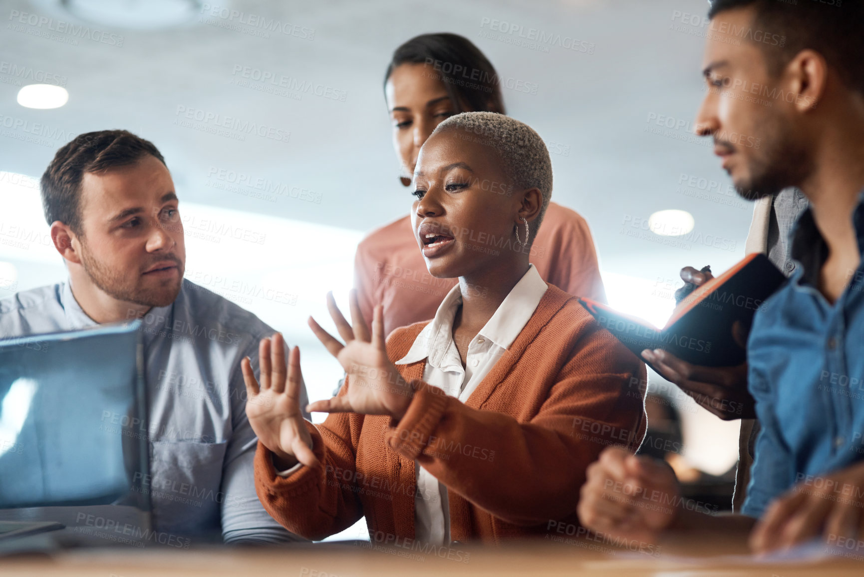 Buy stock photo Shot of a group of young businesspeople using a laptop at a conference in a modern office