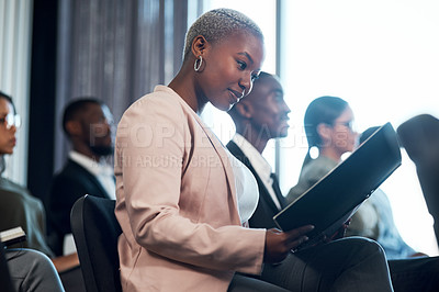 Buy stock photo Shot of a group of businesspeople taking notes during a meeting in an office