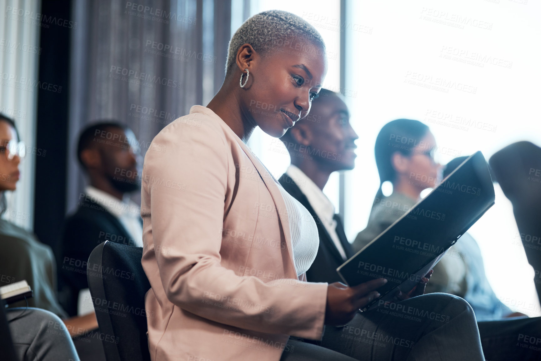 Buy stock photo Shot of a group of businesspeople taking notes during a meeting in an office