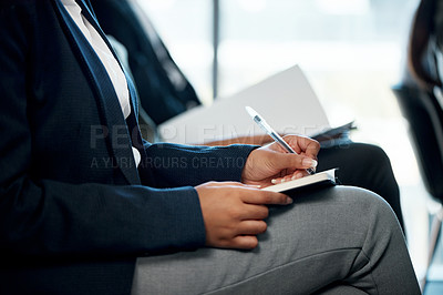 Buy stock photo Shot of a group of unrecognizable businesspeople taking notes during a meeting in an office