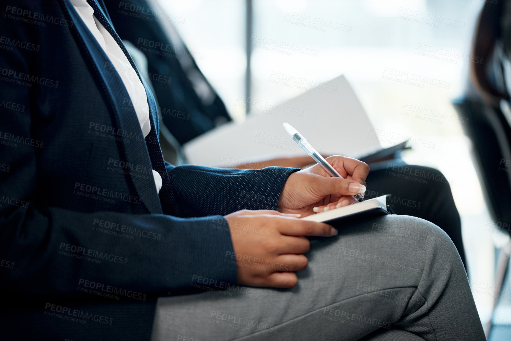 Buy stock photo Shot of a group of unrecognizable businesspeople taking notes during a meeting in an office