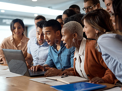 Buy stock photo Shot of a group of young businesspeople using a laptop and looking shocked in a modern office