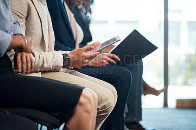 Buy stock photo Shot of a group of unrecognizable businesspeople using digital tablets and notepads during a conference