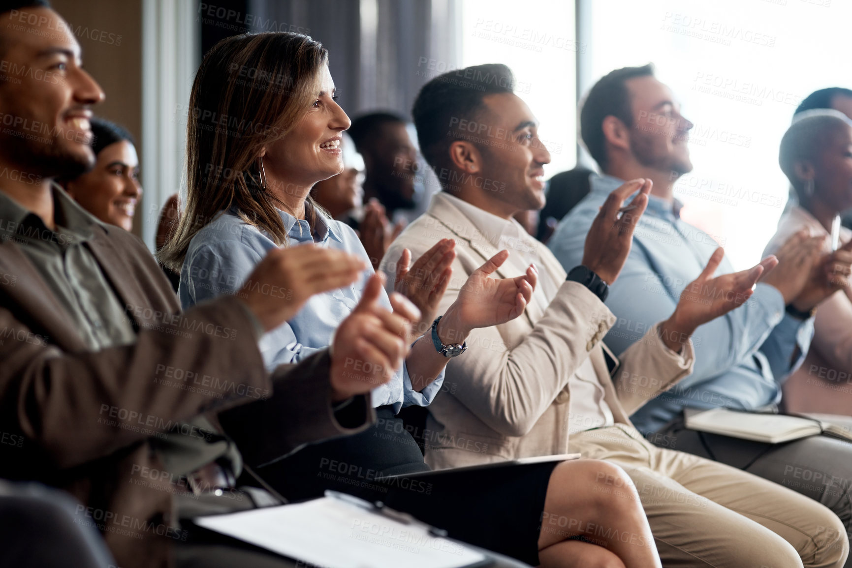 Buy stock photo Shot of a group of young businesspeople clapping during a conference in a modern office