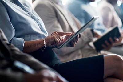 Buy stock photo Shot of a group of unrecognizable businesspeople using digital tablets and notepads during a conference