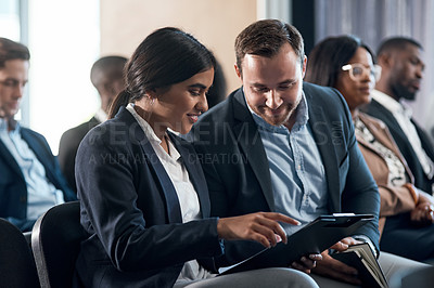 Buy stock photo Shot of a group of  businesspeople using a digital tablets during a conference