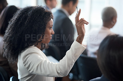 Buy stock photo Shot of a young businesswoman raising her hand during a conference in a modern office