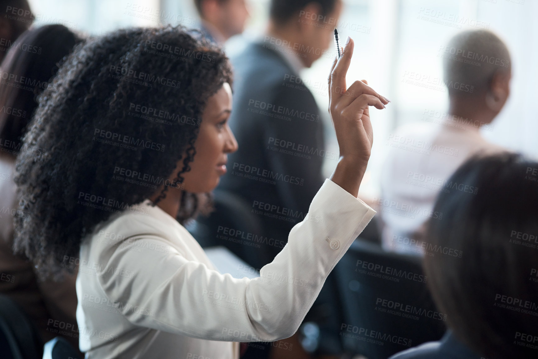 Buy stock photo Shot of a young businesswoman raising her hand during a conference in a modern office