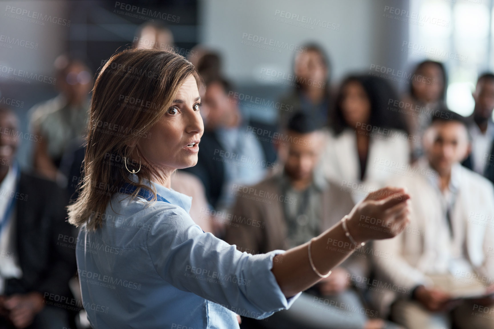 Buy stock photo Presentation, training and coaching with a business woman talking to an audience during a workshop. Convention, speech and teaching with a female speaker giving a seminar to a group of employees
