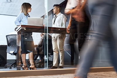 Buy stock photo Shot of a businessman and businesswoman having a meeting in a modern office