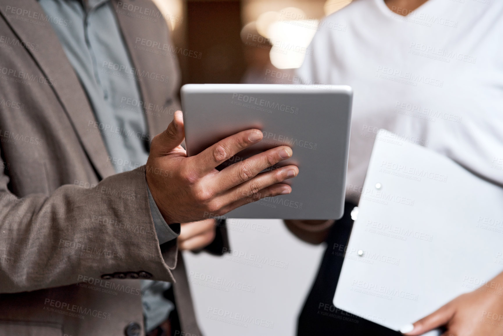 Buy stock photo Shot of a businessman and businesswoman using a digital tablet at a conference