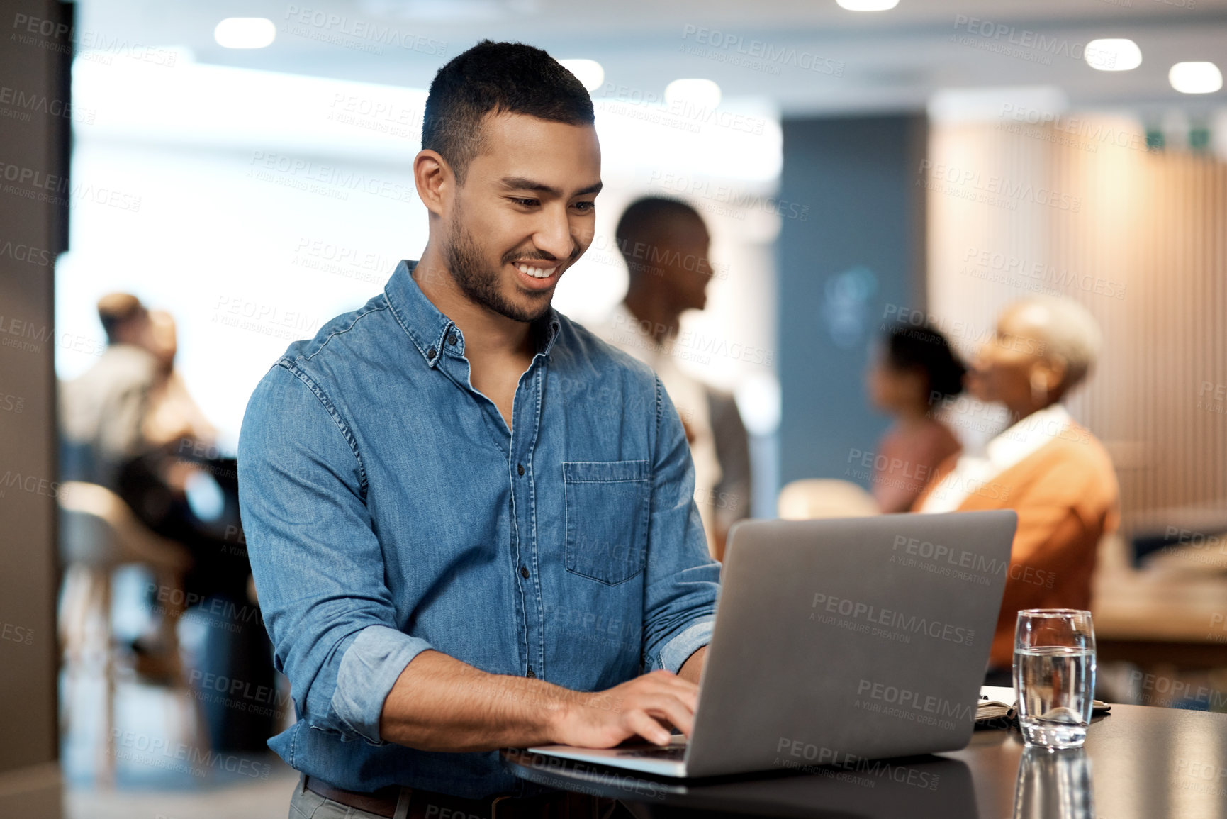 Buy stock photo Shot of a young businessman using a laptop at a conference