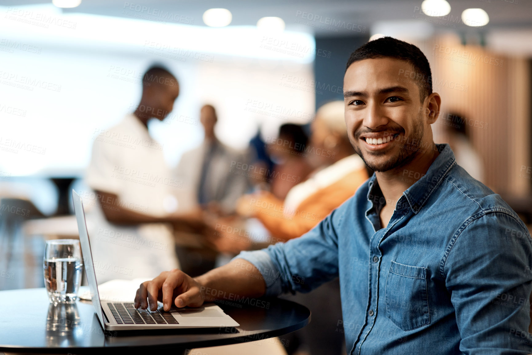 Buy stock photo Shot of a young businessman using a laptop at a conference