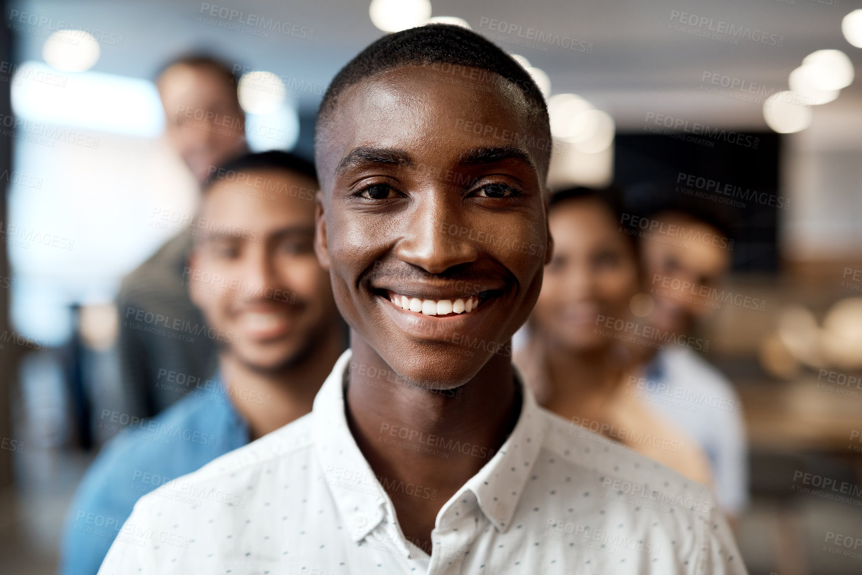 Buy stock photo Portrait of a group of confident young businesspeople working together in a modern office