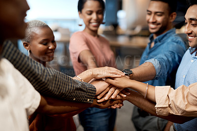 Buy stock photo Shot of a group of businesspeople joining hands in solidarity in a modern office