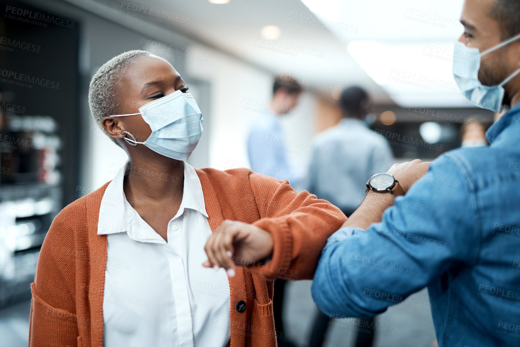 Buy stock photo Shot of a masked young businessman and businesswoman greeting each other with an elbow bump at a conference