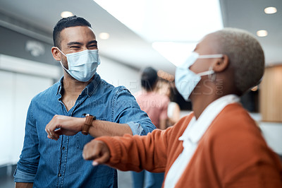 Buy stock photo Shot of a masked young businessman and businesswoman greeting each other with an elbow bump at a conference