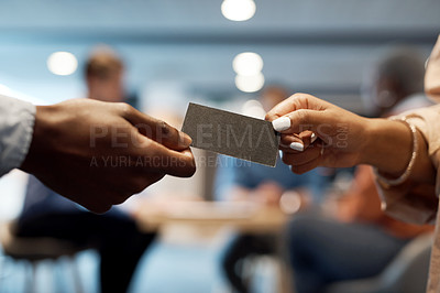 Buy stock photo Shot of two businesspeople exchanging business cards at a conference