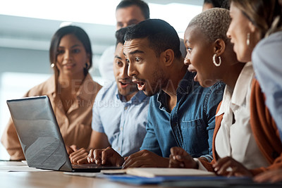 Buy stock photo Shot of a group of young businesspeople using a laptop and looking shocked in a modern office