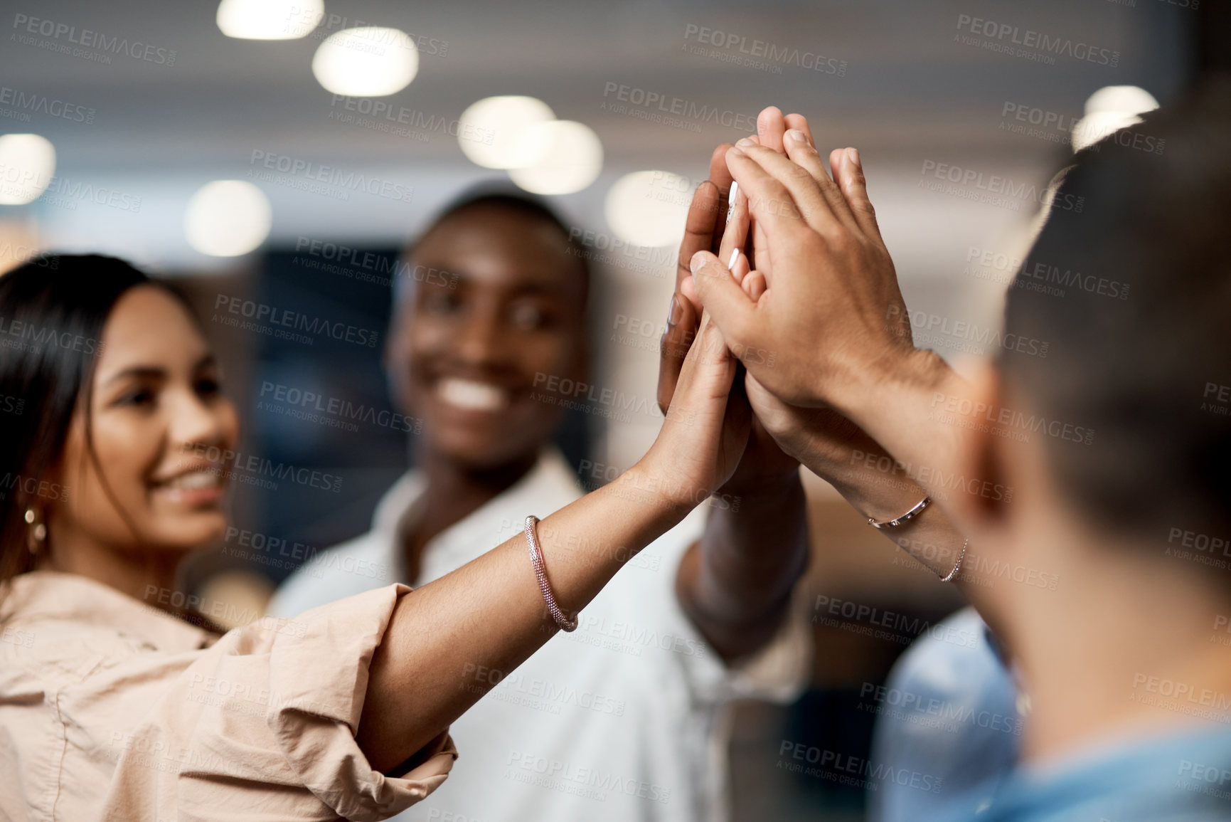 Buy stock photo Shot of a group of businesspeople joining hands in solidarity in a modern office