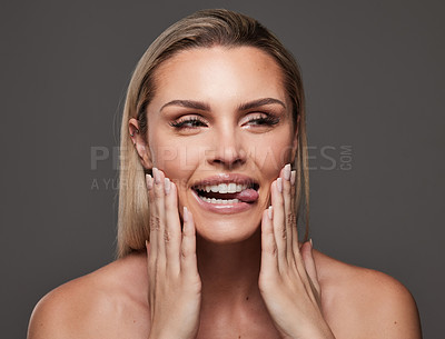 Buy stock photo Studio shot of a beautiful young woman standing against a grey background