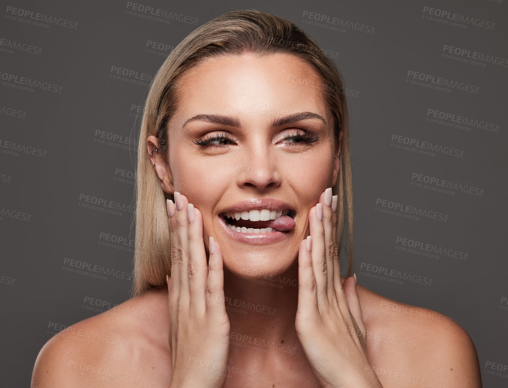 Buy stock photo Studio shot of a beautiful young woman standing against a grey background