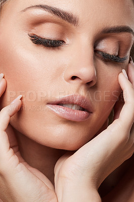 Buy stock photo Studio shot of a beautiful young woman standing against a grey background