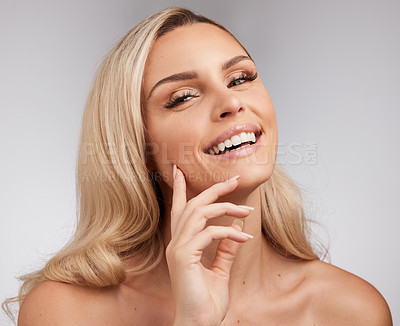 Buy stock photo Studio shot of a beautiful young woman standing against a grey background