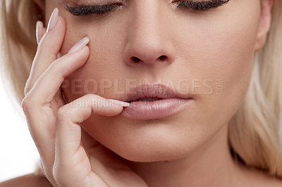 Buy stock photo Studio shot of a beautiful young woman posing against a white background