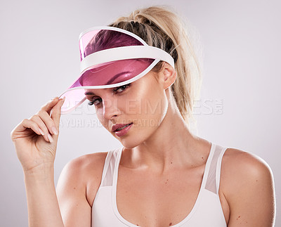 Buy stock photo Studio shot of a sporty young woman posing against a grey background