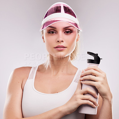 Buy stock photo Studio shot of a sporty young woman posing against a grey background