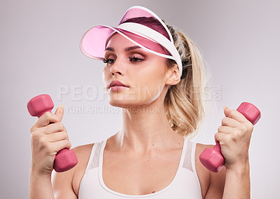 Buy stock photo Studio shot of a sporty young woman posing against a grey background