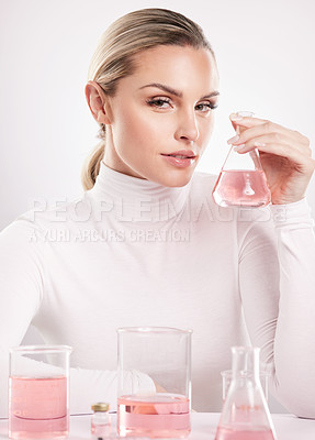 Buy stock photo Studio shot of  young woman making a potion against a white background