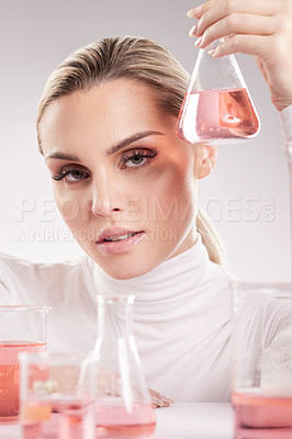 Buy stock photo Studio shot of  young woman making a potion against a white background