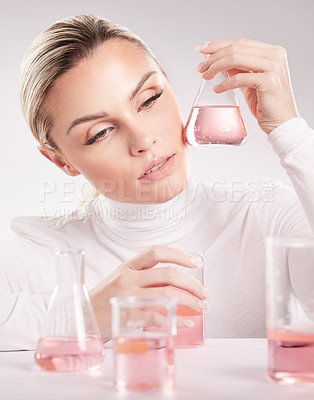 Buy stock photo Studio shot of  young woman making a potion against a white background