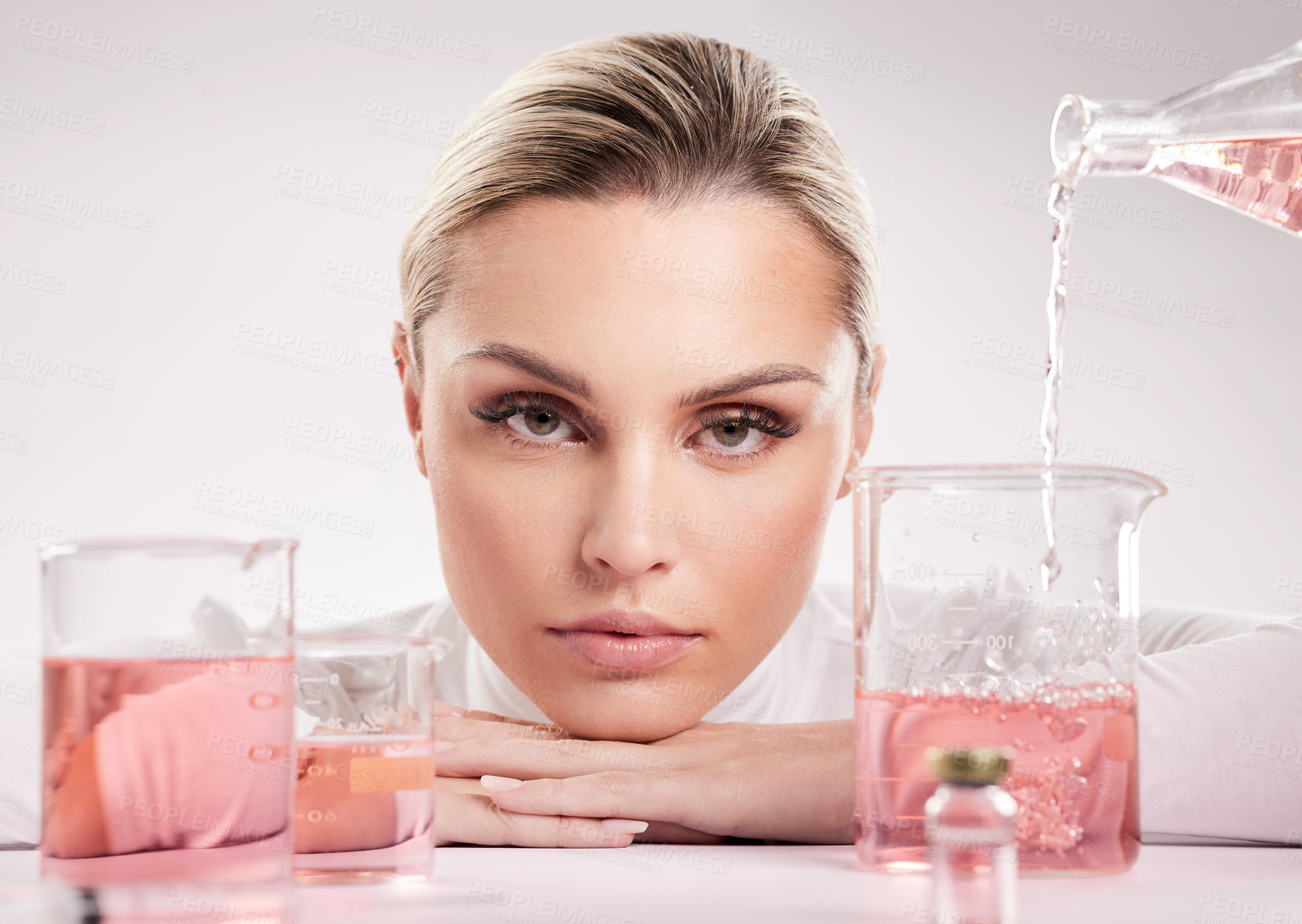 Buy stock photo Studio shot of  young woman making a potion against a white background