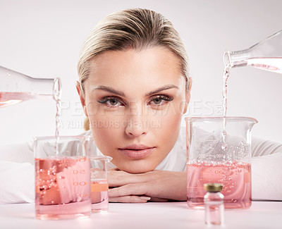 Buy stock photo Studio shot of  young woman making a potion against a white background