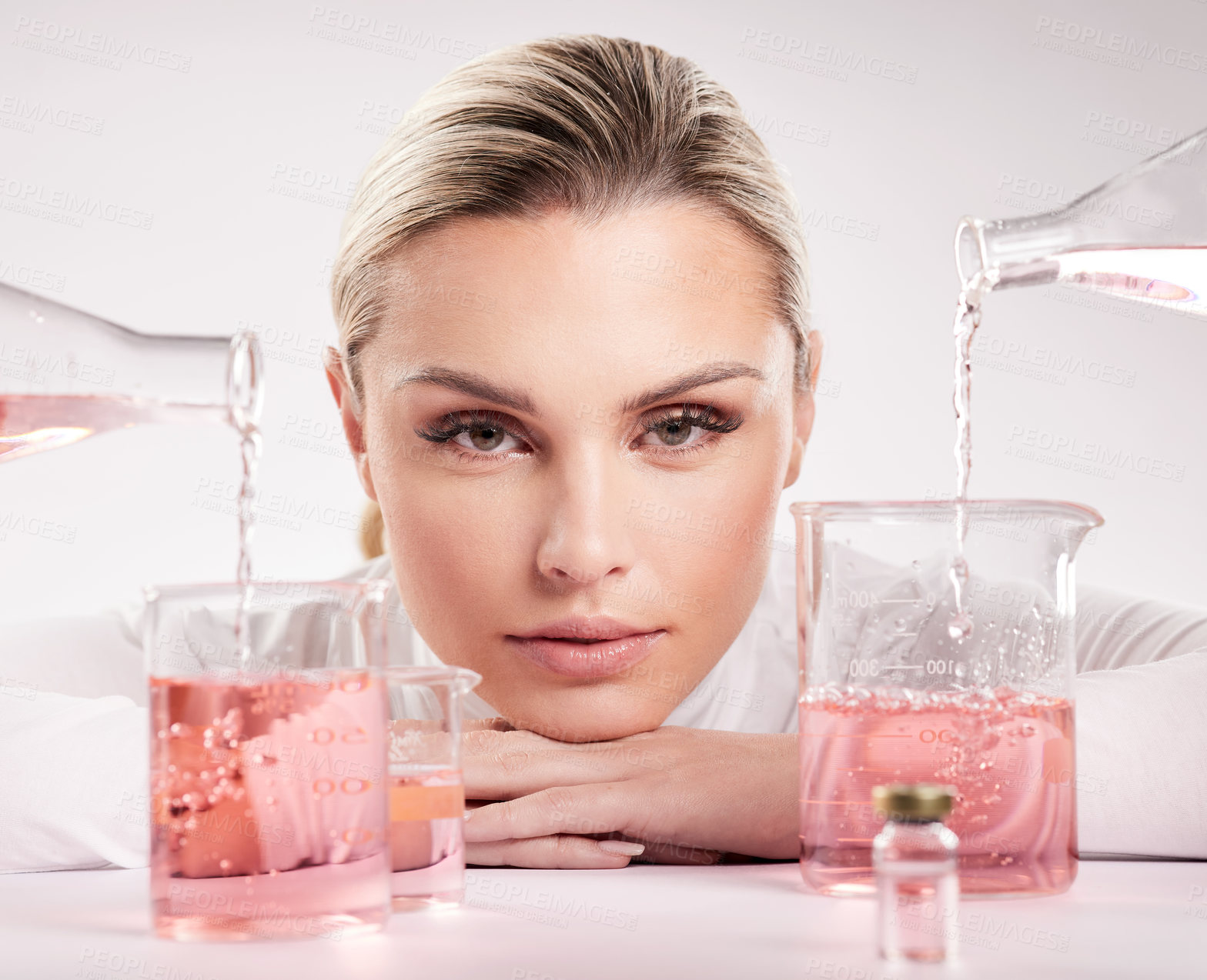 Buy stock photo Studio shot of  young woman making a potion against a white background