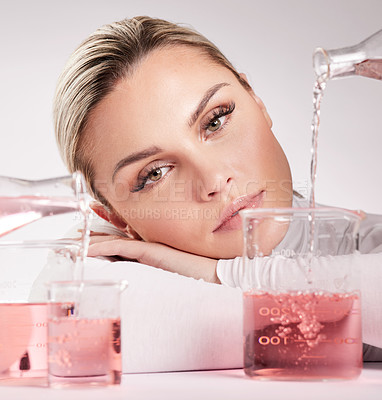 Buy stock photo Studio shot of  young woman making a potion against a white background