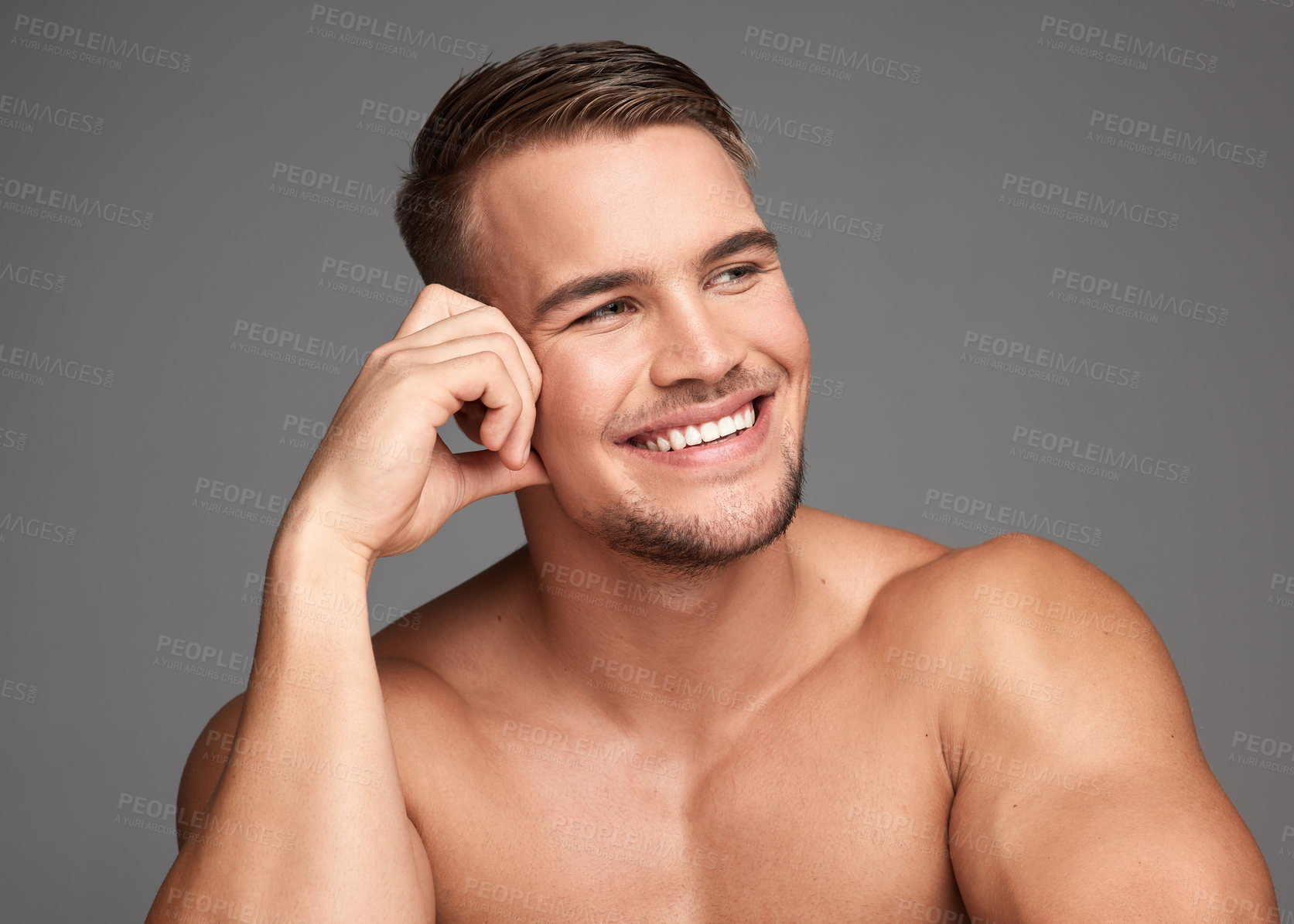 Buy stock photo Studio shot of a handsome young man posing against a grey background