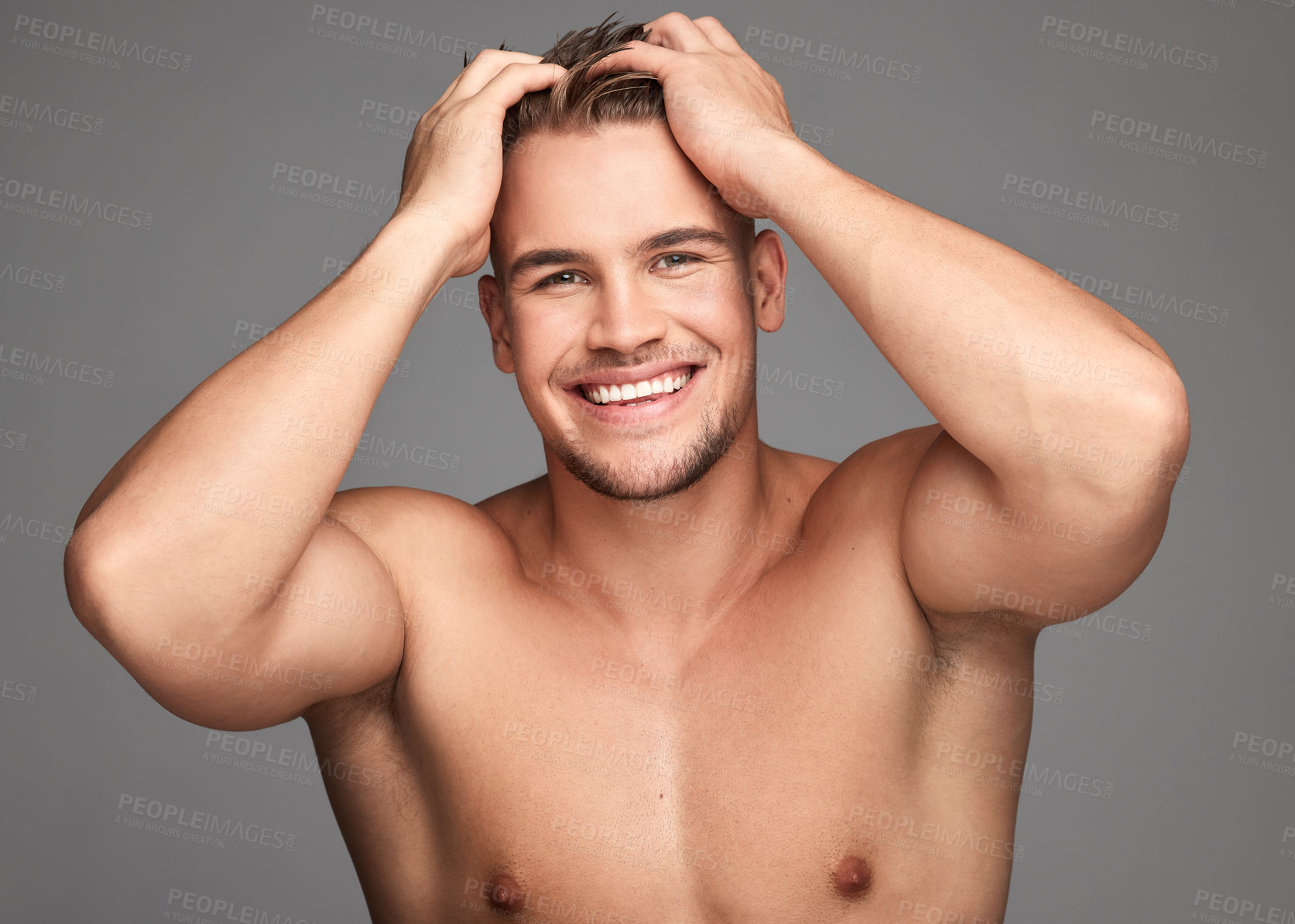 Buy stock photo Studio shot of a handsome young man posing against a grey background