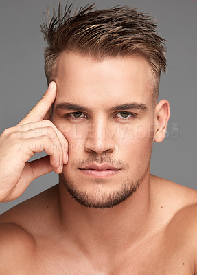 Buy stock photo Studio shot of a handsome young man posing against a grey background