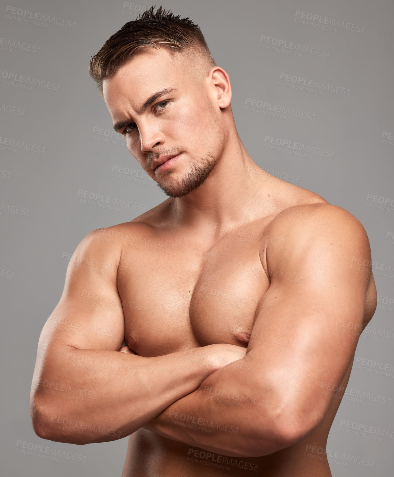 Buy stock photo Studio shot of a handsome young man posing against a grey background