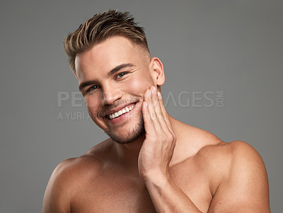 Buy stock photo Studio shot of a handsome young man posing against a grey background