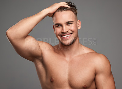 Buy stock photo Studio shot of a handsome young man posing against a grey background