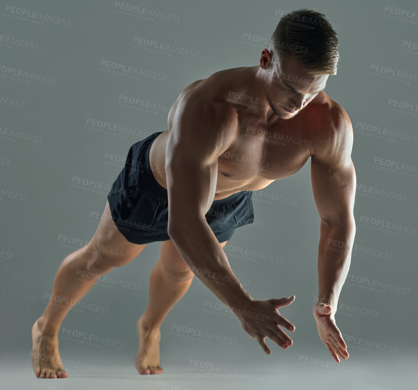 Buy stock photo Shot of a young athlete doing push-ups against a studio background