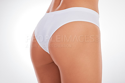 Buy stock photo Cropped shot of an unrecognizable woman standing in her underwear and posing in the studio