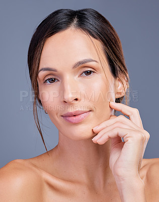 Buy stock photo Shot of a young woman admiring her skin against a studio background