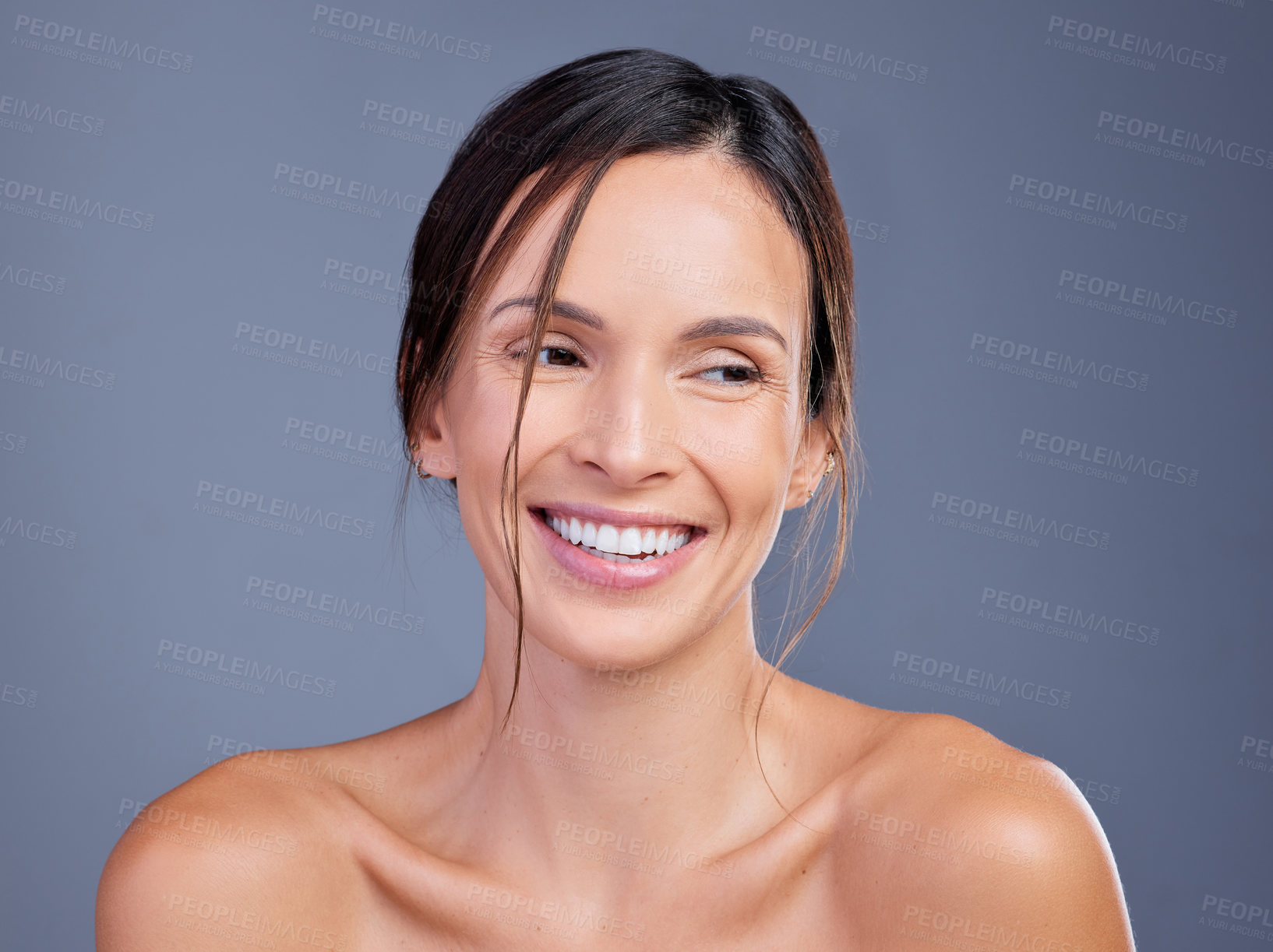 Buy stock photo Shot of a young woman admiring her skin against a studio background